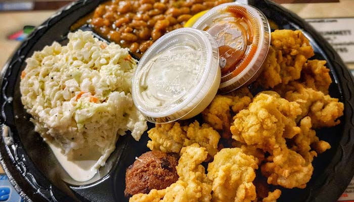 Fried seafood platter with coleslaw and baked beans at Scooter's Fish House best seafood restaurant in Navarre Florida